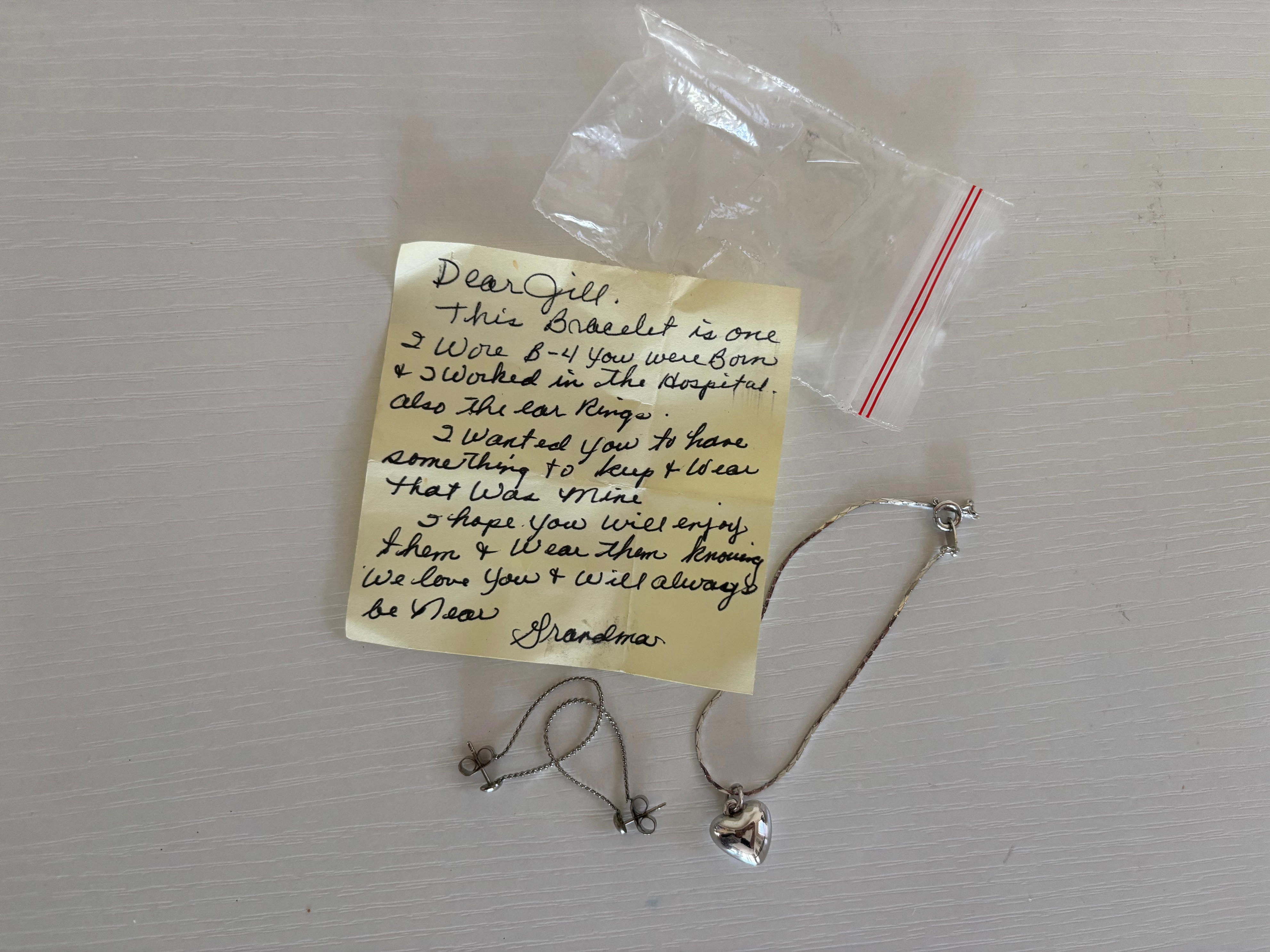 a bracelet and set of earrings in a bag with a handwritten note