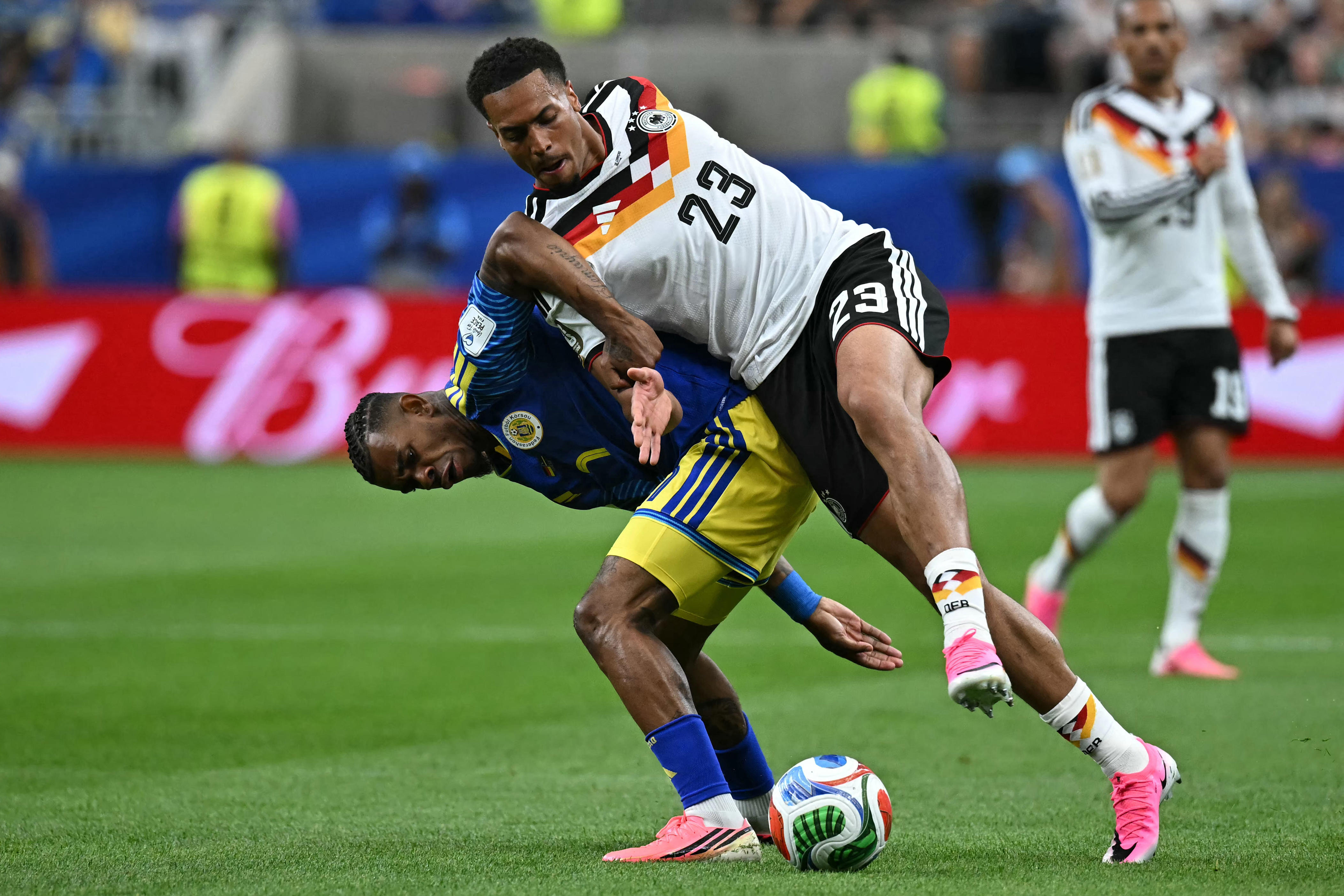 Curacao's midfielder #7 Juninho Bacuna (L) fights for the ball with Germany's defender #23 Felix Nmecha during the 2026 World Cup Group E football match between Germany and Curacao at the Houston Stadium in Houston on June 14, 2026.