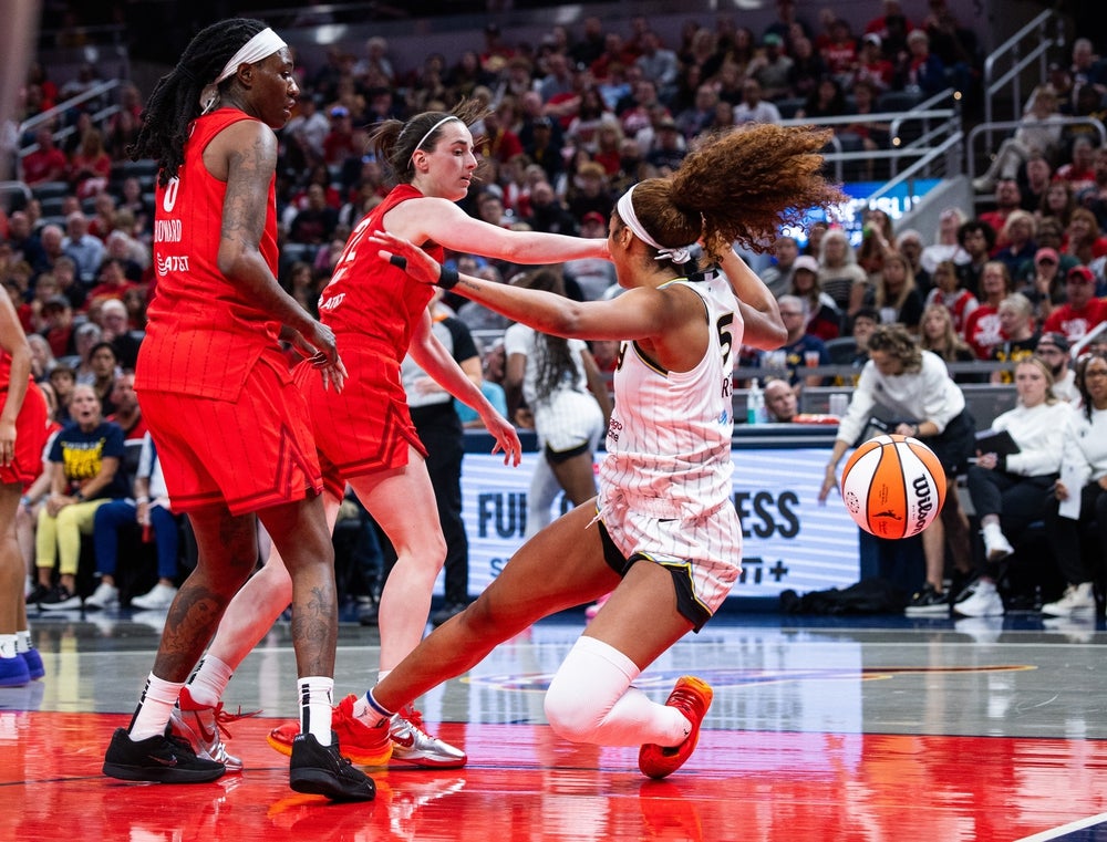 May 17, 2025; Indianapolis, Indiana, USA; Indiana Fever guard Caitlin Clark (22) fouls Chicago Sky forward Angel Reese (5) in the second half at Gainbridge Fieldhouse. Mandatory Credit: Trevor Ruszkowski-Imagn Images