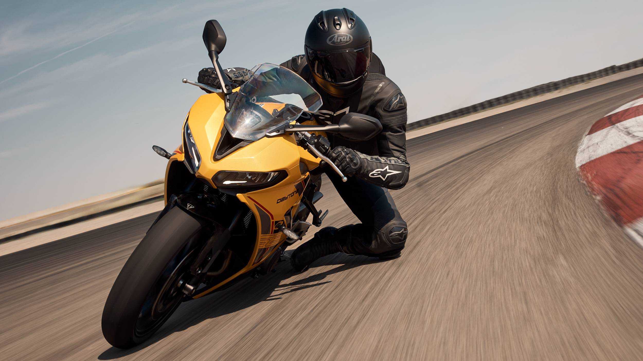 Action shot of a rider getting a knee down on a 2026 Daytona 660