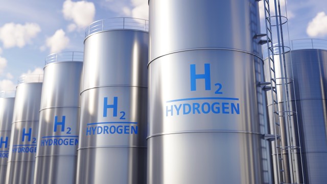 Row of metallic hydrogen storage tanks with blue