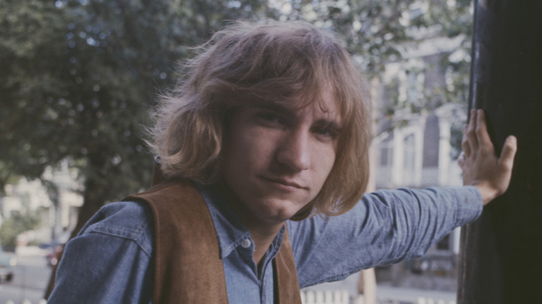Joe Walsh leaning on a pole