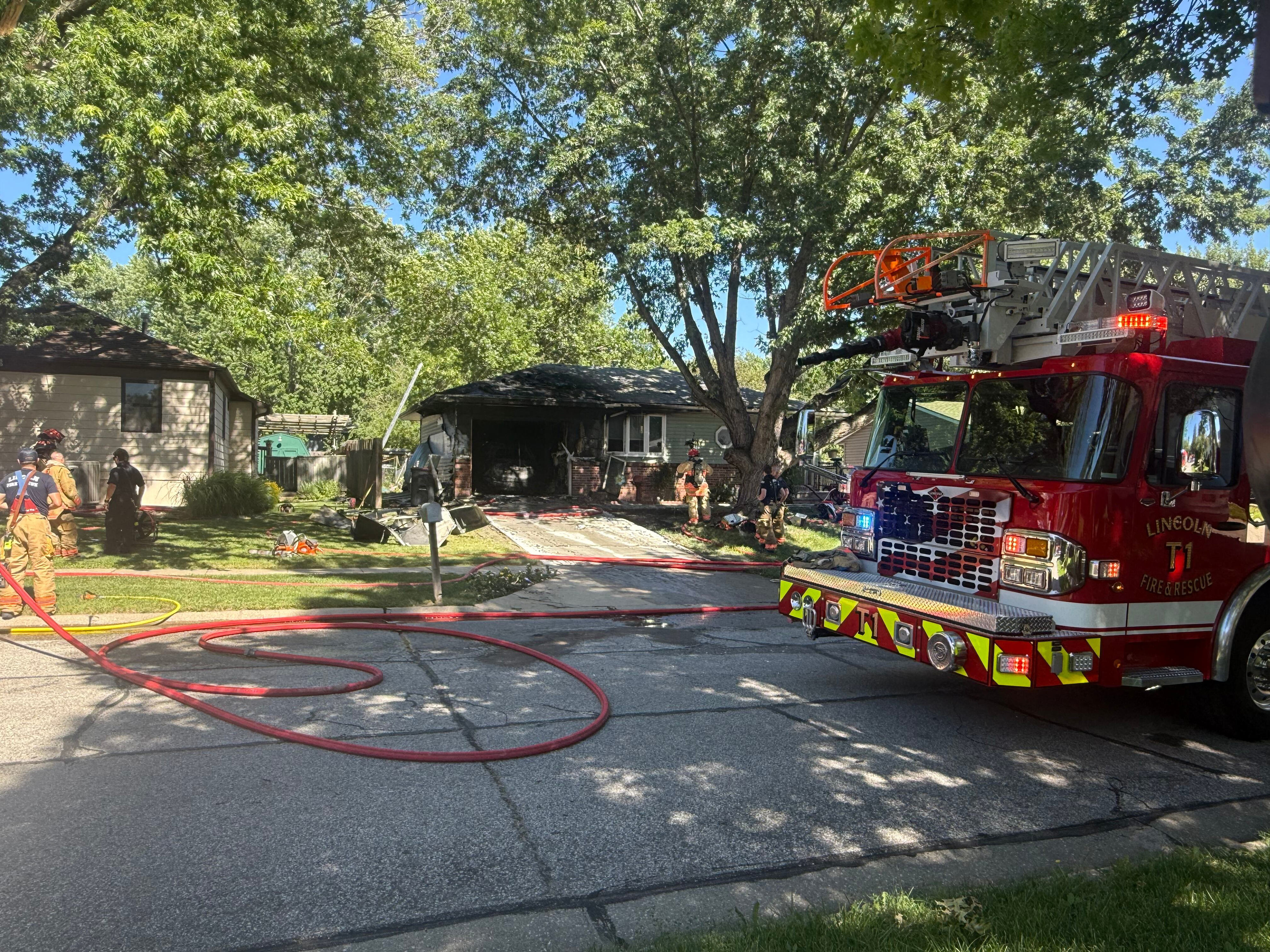 Live: North Lincoln garage fire leaves car scorched, structure damaged