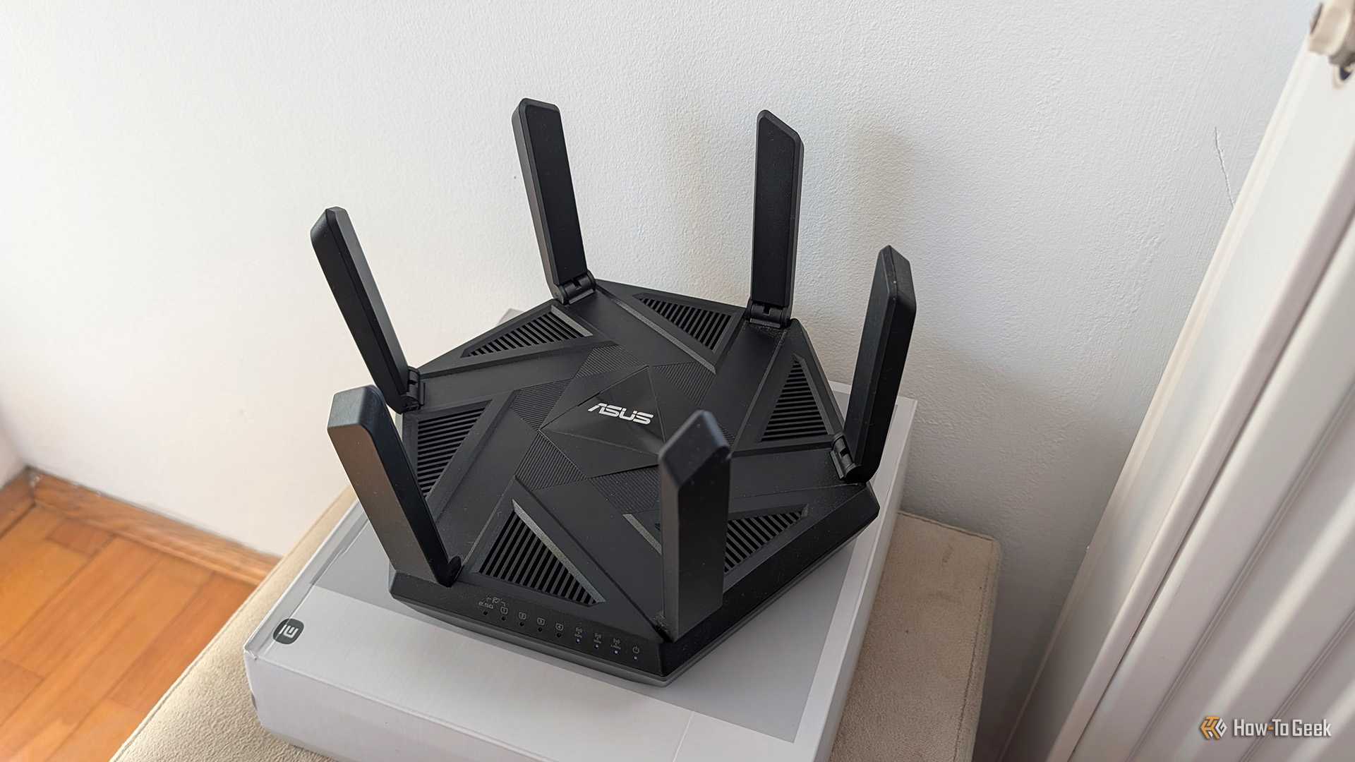 An ASUS Wi-Fi 6E router placed on a box.