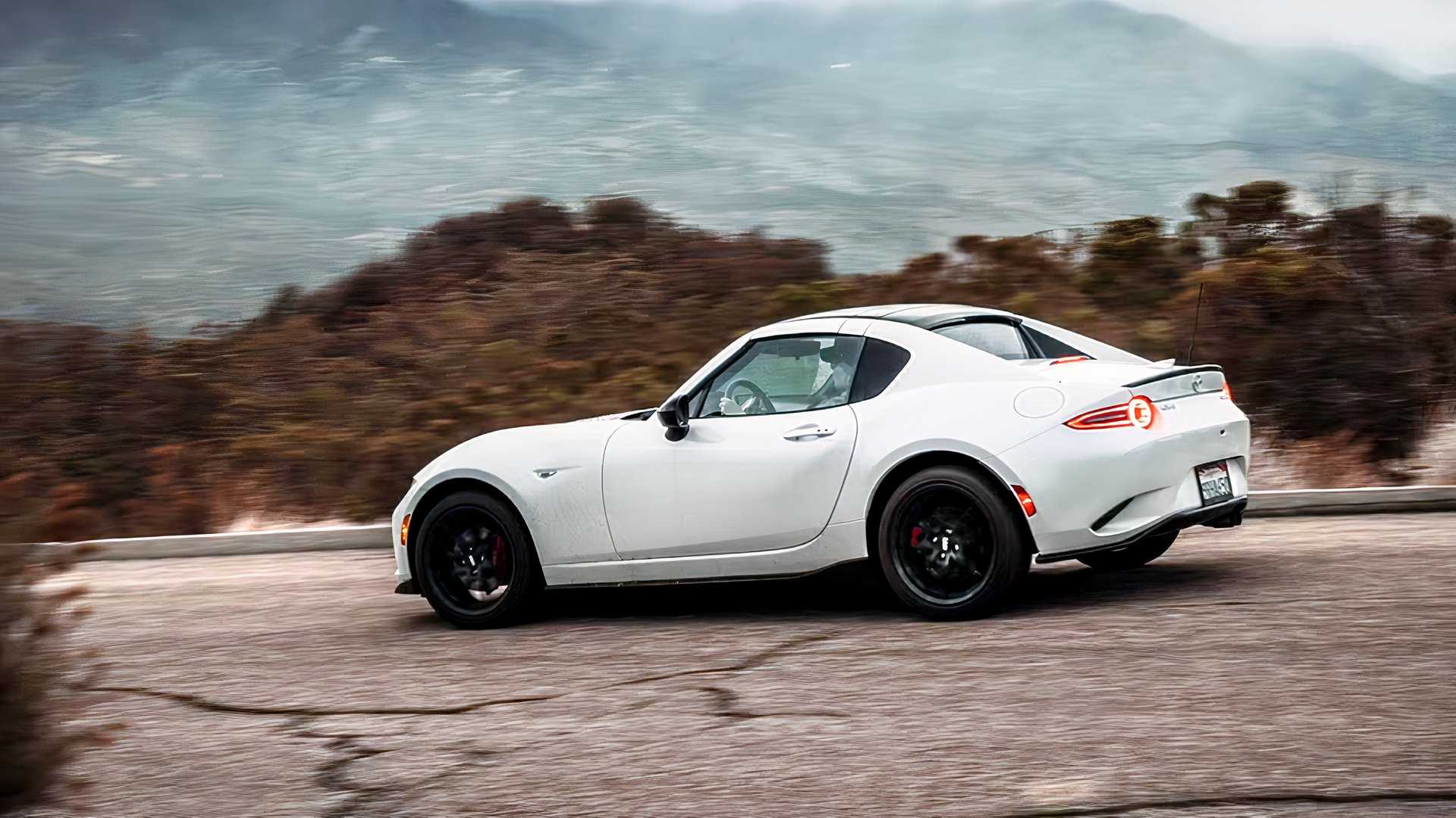 Rear 3/4 action shot of 2026 Mazda MX-5 Miata RF driving
