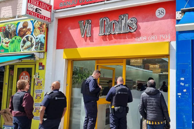 Immigration officers outside Vi Nails on June 10