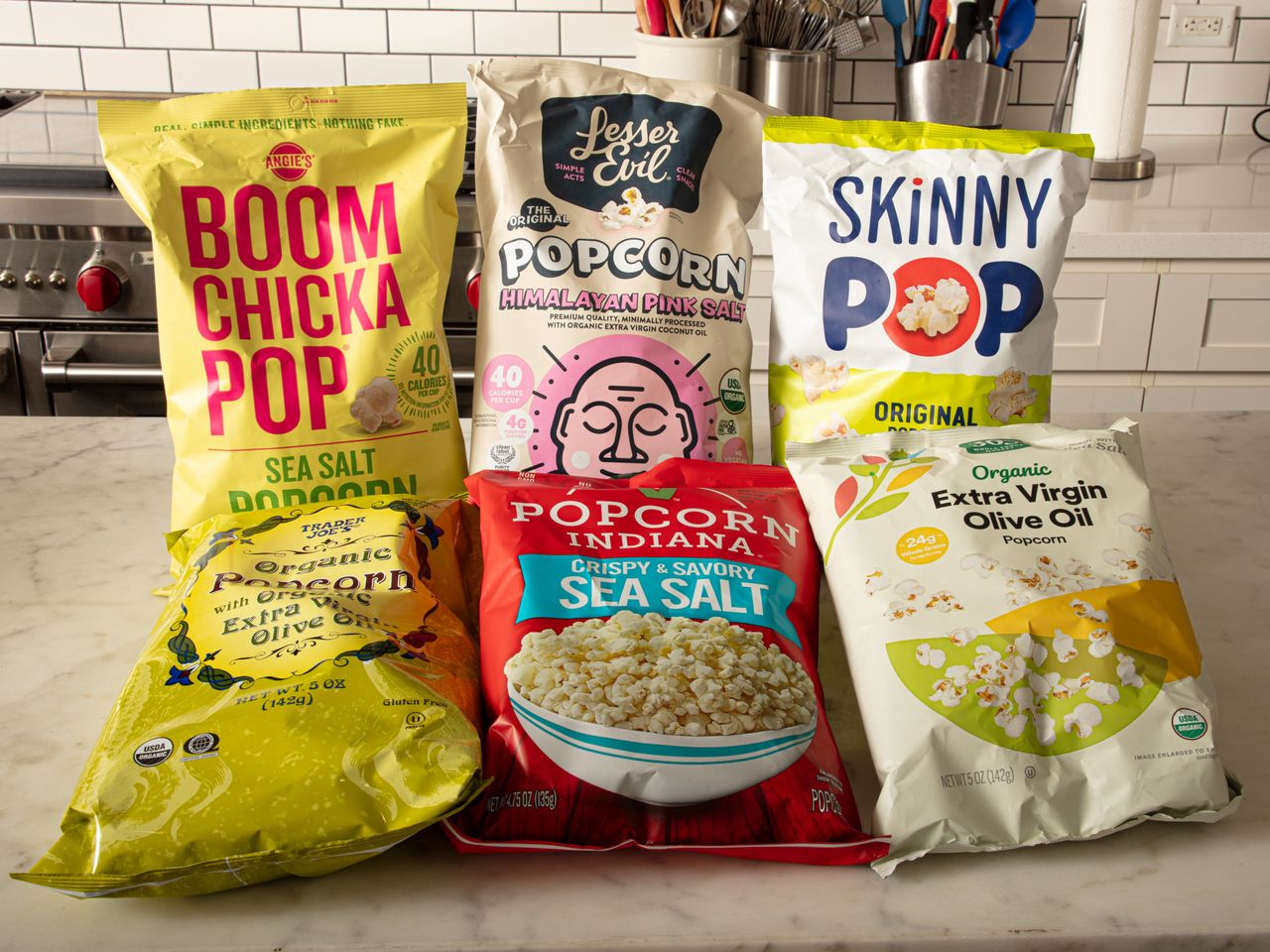 Assorted sea salt popcorn brands displayed on a counter