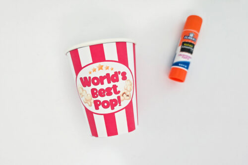 A striped paper cup labeled