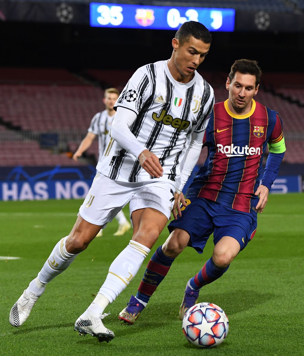 Cristiano Ronaldo of Juventus F.C. is put under pressure by Lionel Messi of Barcelona during the UEFA Champions League Group G stage match between FC Barcelona and Juventus