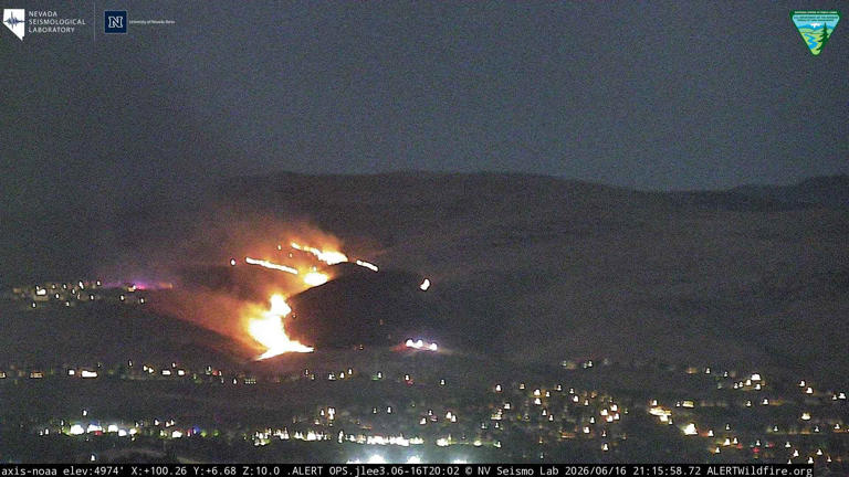 Evacuations lifted as crews battle Sparks brush fire