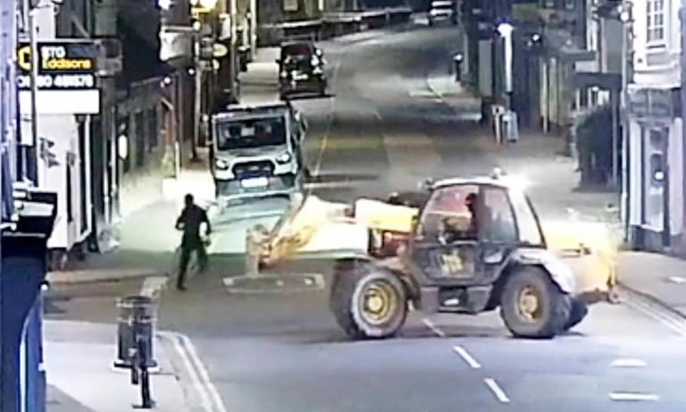 Moment balaclava-clad thieves use a stolen telehandler to rip a cash ...