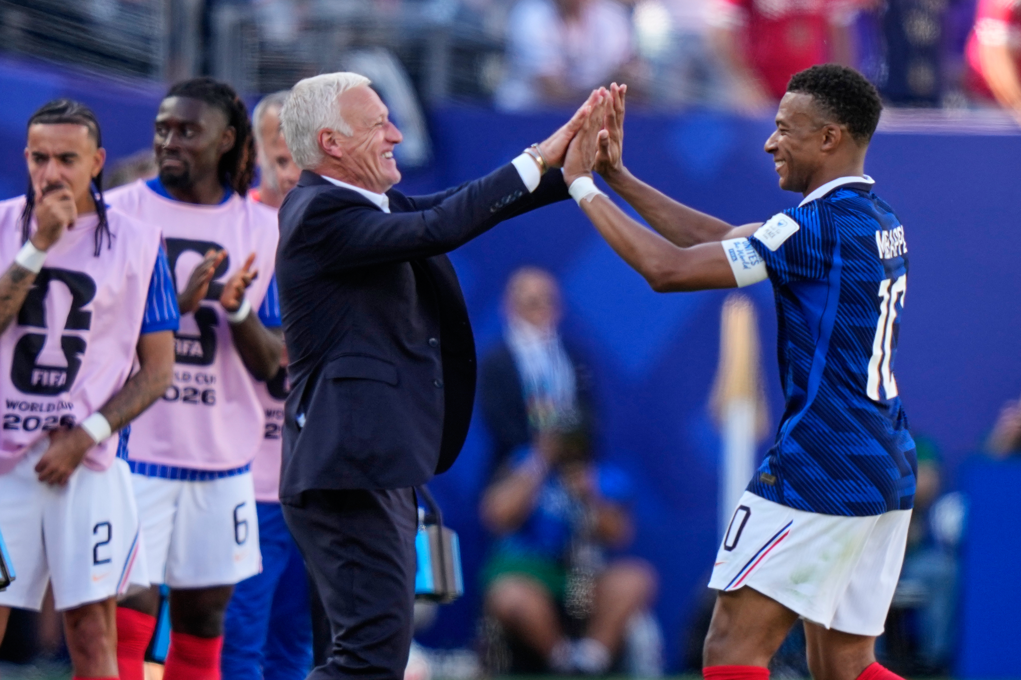 France's Kylian Mbappe, right, celebrates with France head coach Didier Deschamps after scoring his side's third goal during the World Cup Group I soccer match between France and Senegal in East Rutherford, N.J., near New York, Tuesday, June 16, 2026. (AP Photo/Frank Franklin II)