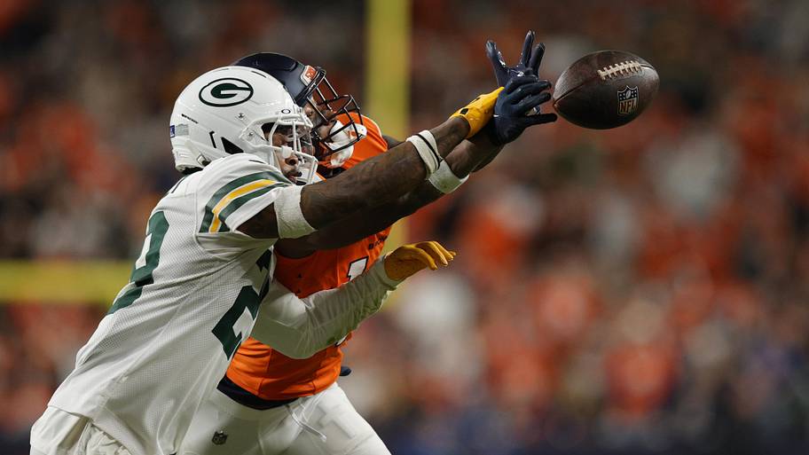 Green Bay Packers safety Xavier McKinney (29) deflects a pass intended for Denver Broncos receiver Courtland Sutton.
