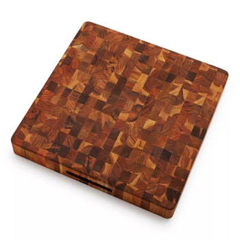Square wooden cutting board with an intricate, end-grain pattern, ideal for kitchen use
