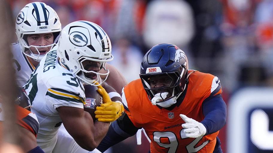 Green Bay Packers running back Chris Brooks runs the ball against the Denver Broncos.