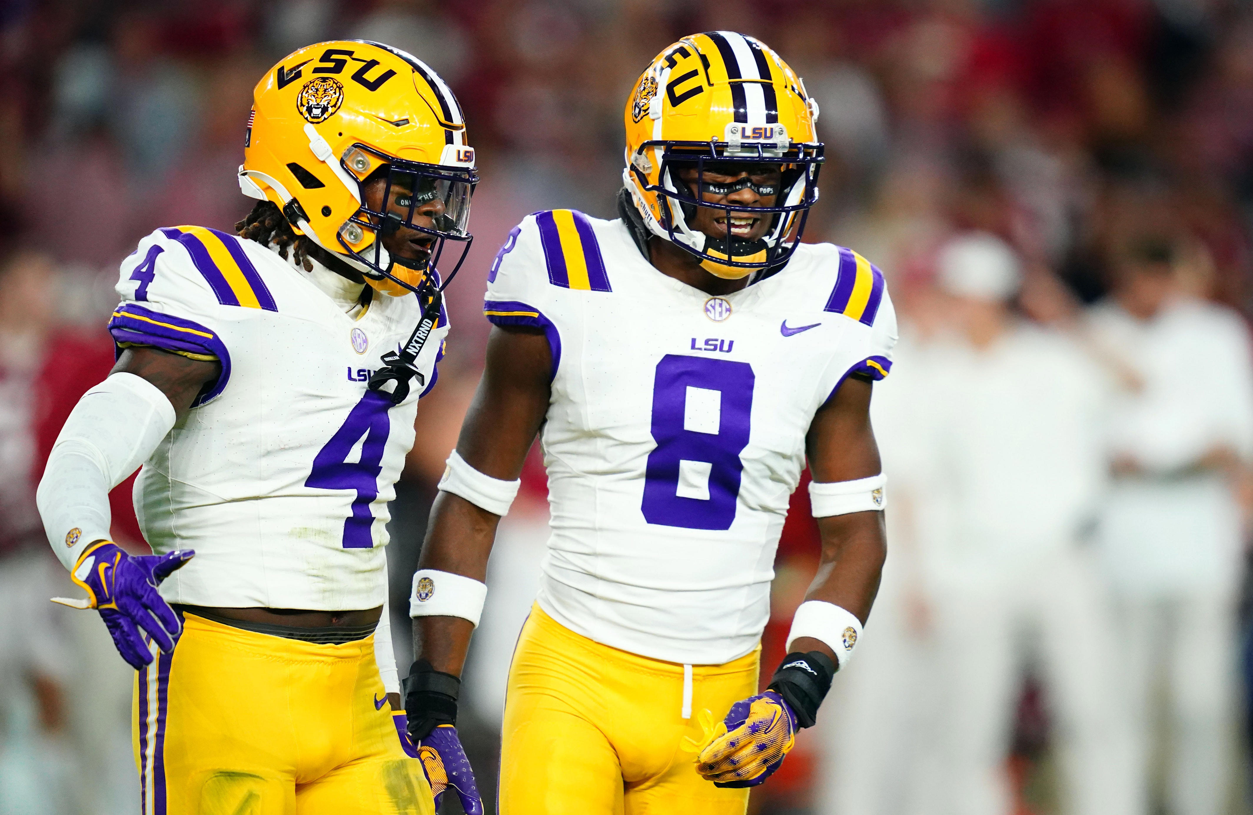 Nov 4, 2023; Tuscaloosa, Alabama, USA; LSU Tigers linebacker Harold Perkins Jr. (4) and safety Major Burns (8) reacts after sacking Alabama Crimson Tide quarterback Jalen Milroe (not pictured) during the first quarter at Bryant-Denny Stadium. Mandatory Credit: John David Mercer-USA TODAY Sports