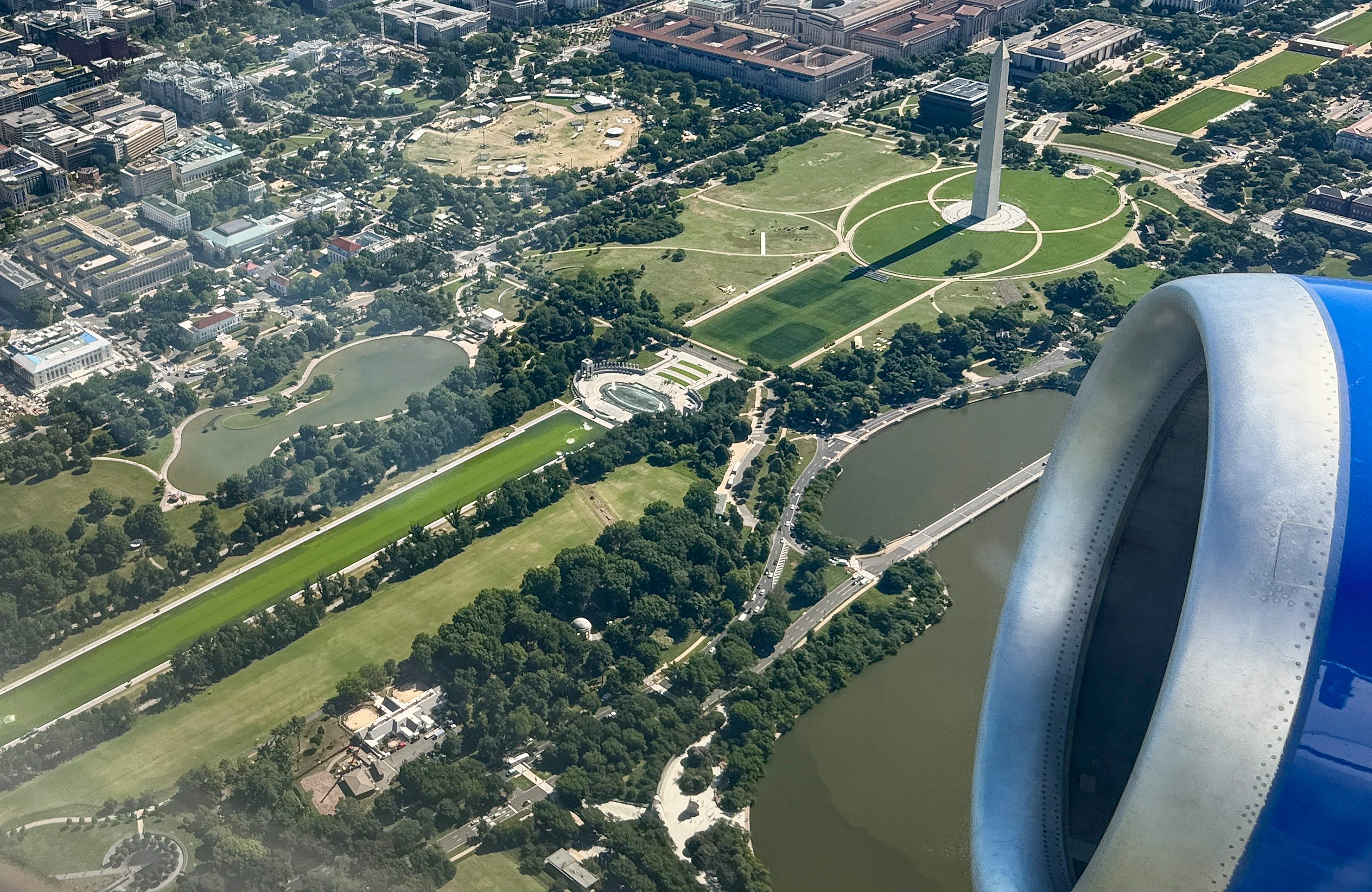 Aerial photo shows green Reflecting Pool, damaged South Lawn, more