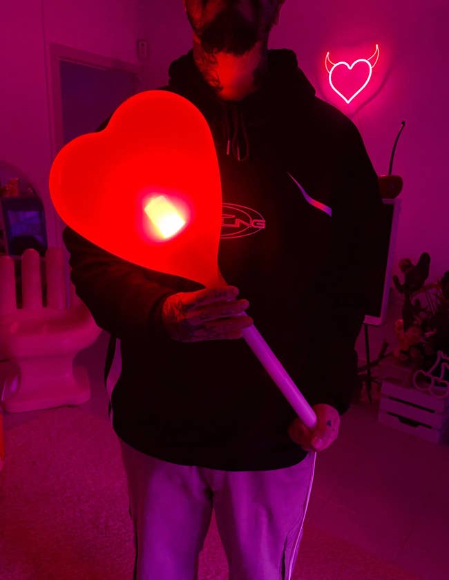 Person holding a large heart-shaped light