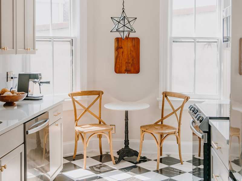 Star shaped light fixture above kitchen bistro table.