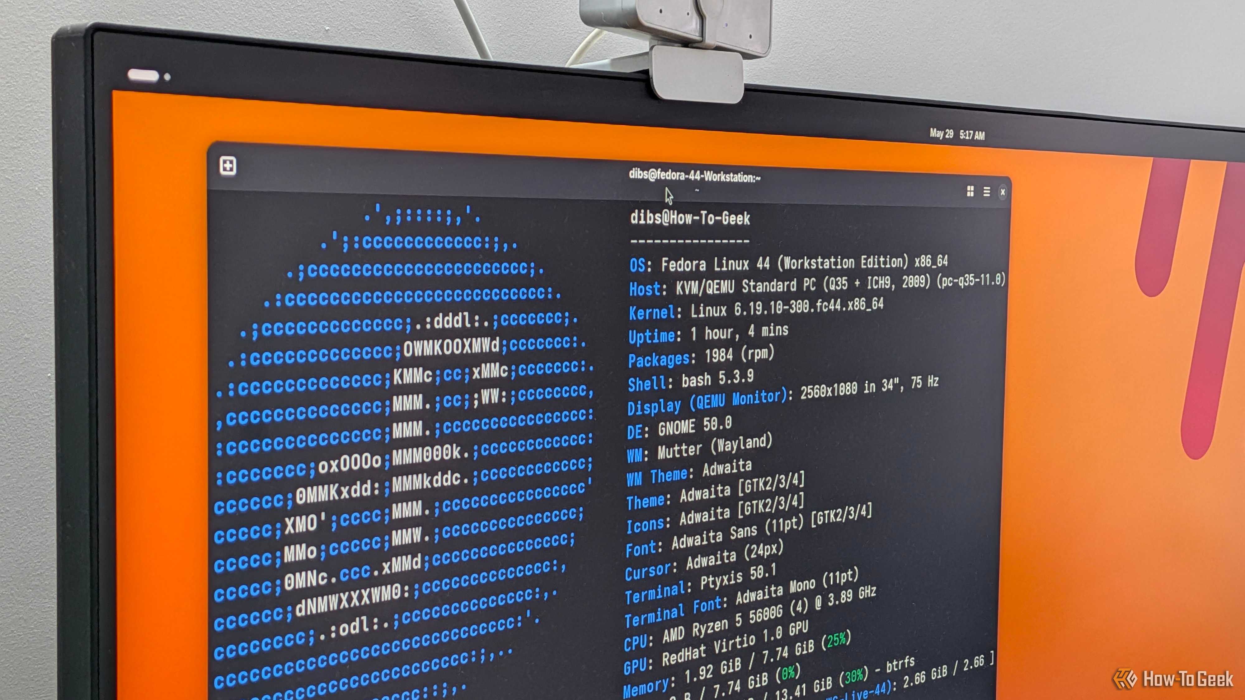 A PC monitor with a Linux terminal open showing the FastFetch output for Fedora.-1