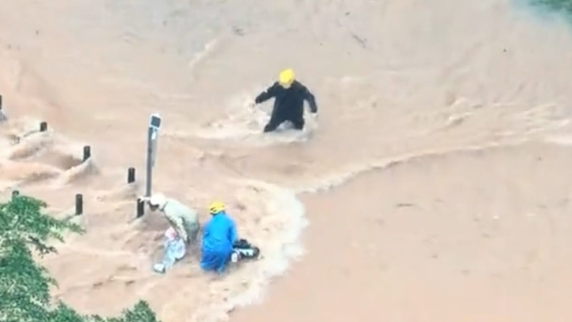 Delivery riders rescue stranded scooter driver during flash flooding in ...