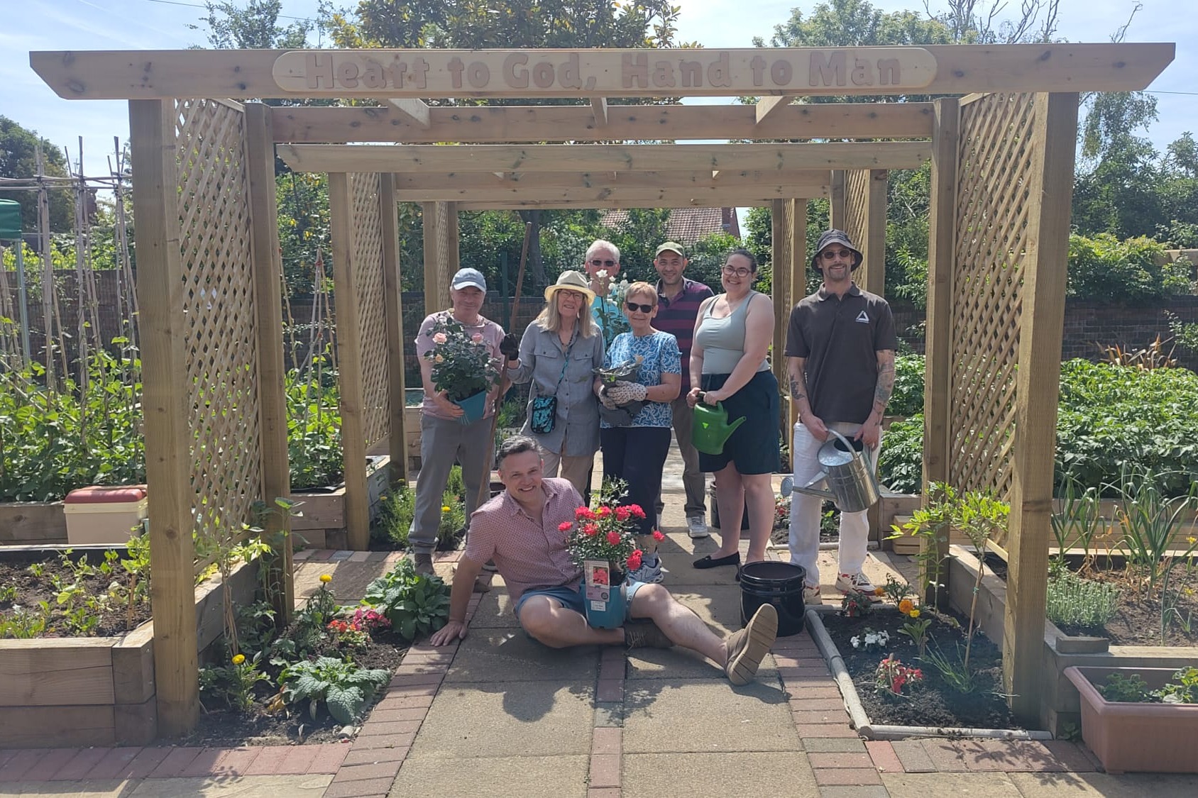 Community turns neglected plot into thriving garden
