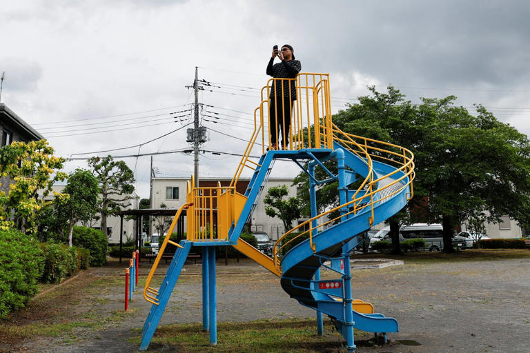 Police officers search for a black bear spotted at a residential area in Utsunomiya