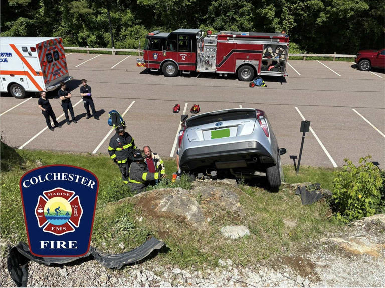 Driver uninjured after car rolls over small cliff in Colchester parking lot