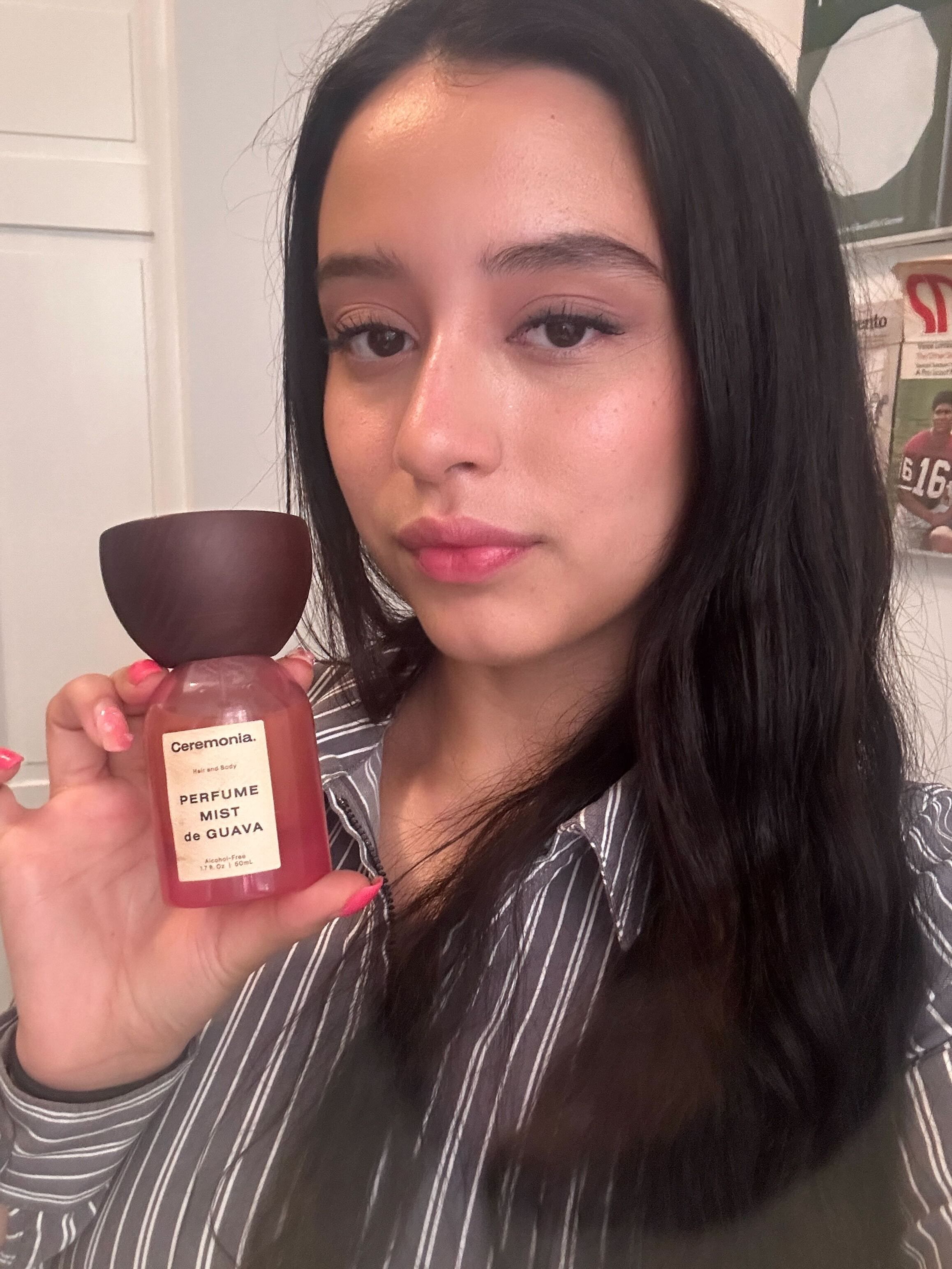Allure designer Briana Rengifo holding a bottle of Ceremonia Perfume Mist de Guava