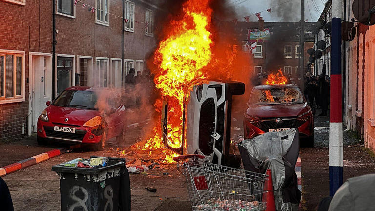 Vehicles set on fire by protesters on Lendrick Street in Belfast, as disorder flared in response to Monday night's stabbing attack in the city. / Credit: PA/PA Images via Getty Images