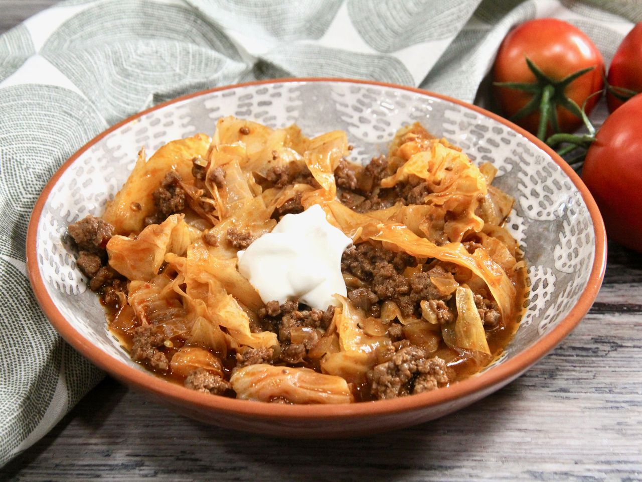 Deconstructed cabbage roll in a bowl topped with sour cream