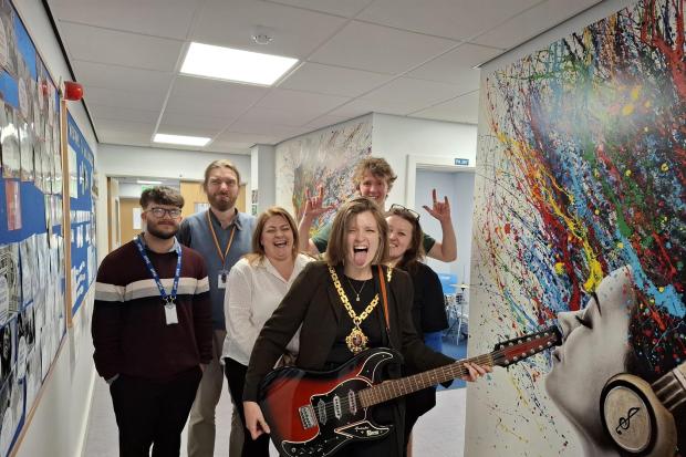 Worcester mayor rocks out on electric guitar on visit to former school