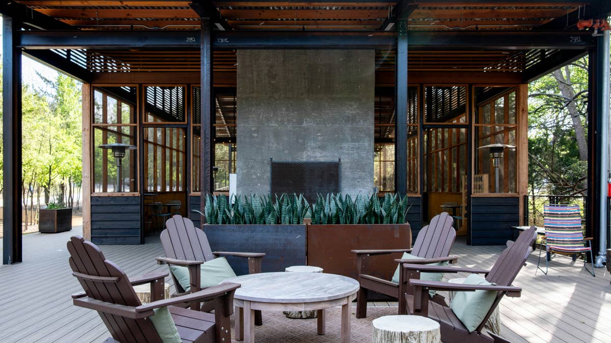 an-outdoor-patio-with-a-fireplace-and-adirondack-chairs-stockpack-unsplash