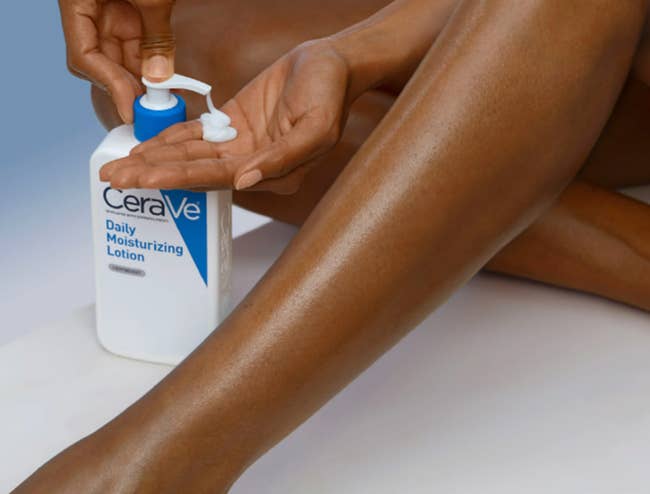 Person applying CeraVe Daily Moisturizing Lotion on their leg, emphasizing skincare routine
