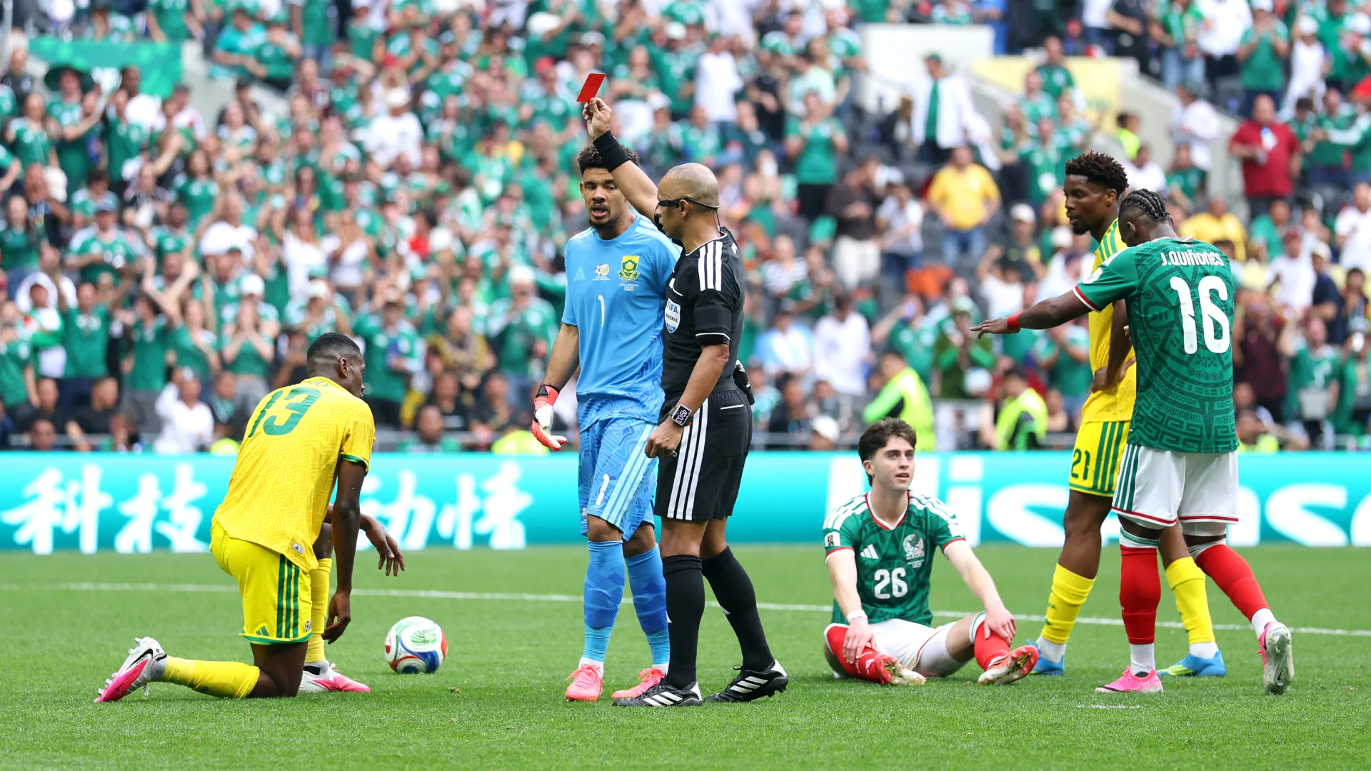 Referee Wilton Sampaio issues a red card to Sphephelo Sithole #13 of South Africa. (Getty Images)