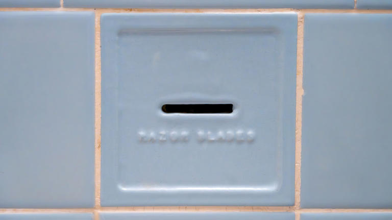 Why are there so many old razor blades in my bathroom wall?