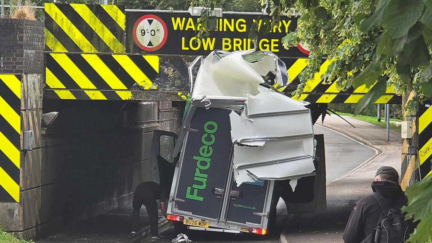 Van loses roof under 'most bashed railway bridge'