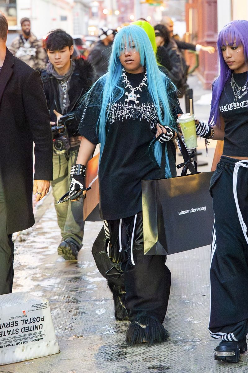 North West rocks an all-leather look, hand piercings and signature blue ...