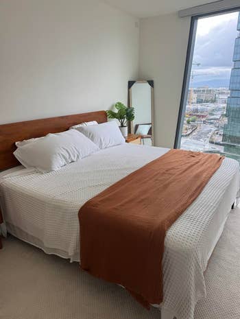 Reviewer's bedroom with white cooling blanket across their bed