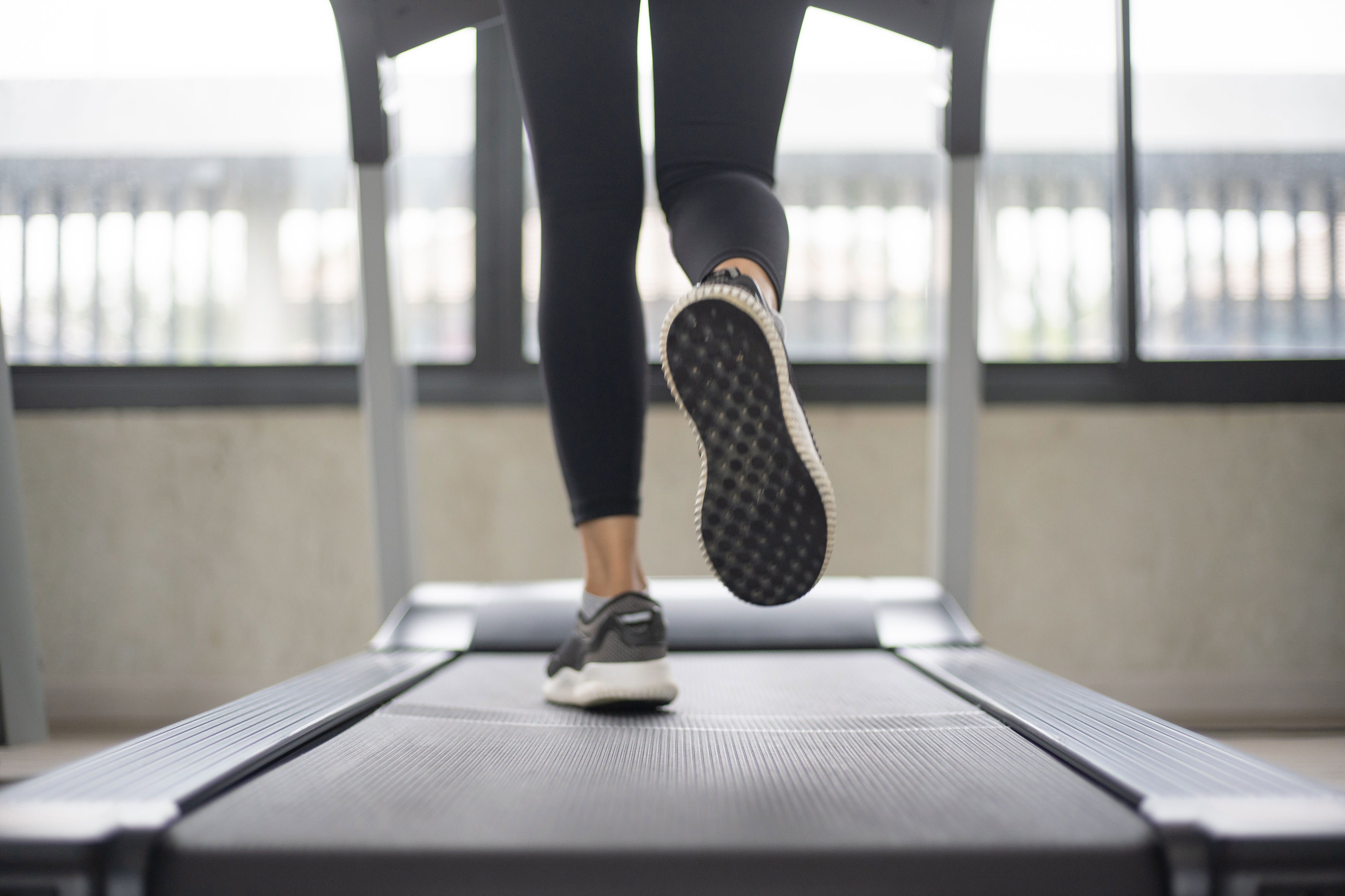 A person running on a treadmill indoors