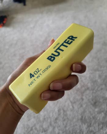 A hand holding a rectangular block labeled