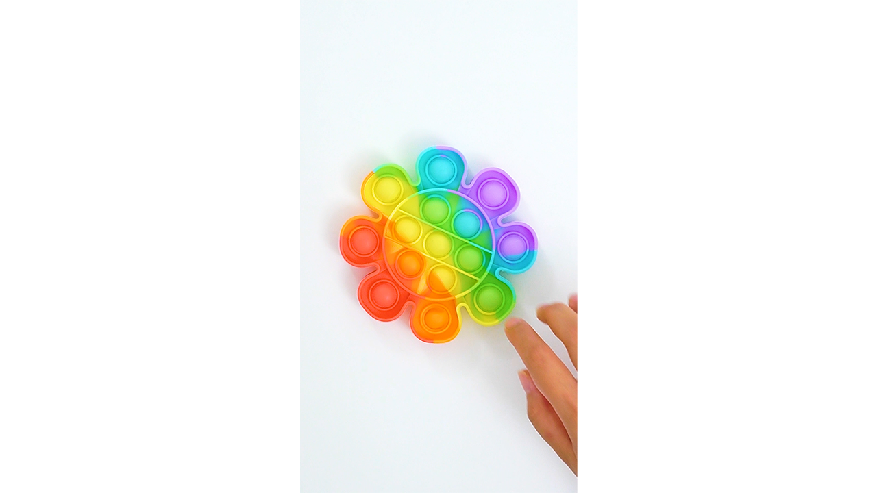 Pressing a rainbow flower pop it with smooth bubble texture