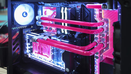 Custom liquid-cooled gaming PC with pink hardline tubing and illuminated components.