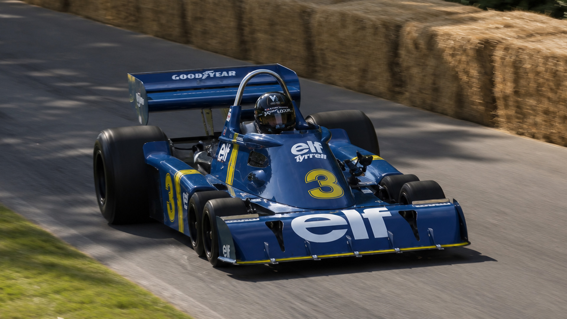 Six wheeled Tyrrell P34 F1 car with a DFV V8 engine in action on track