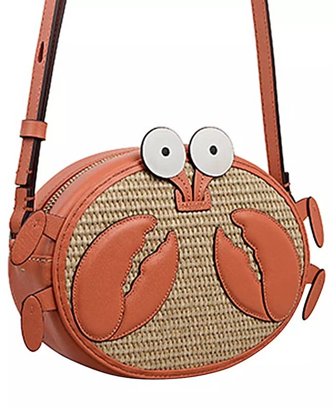Crab-shaped handbag with woven texture, featuring cartoon eyes and orange claw accents, suitable for a playful, nautical-themed look