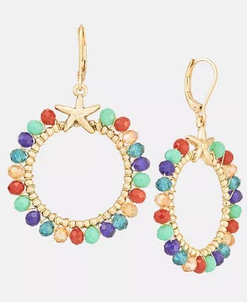 Gold hoop earrings with multicolored beads and a starfish accent at the top, suitable for casual or beachwear styling