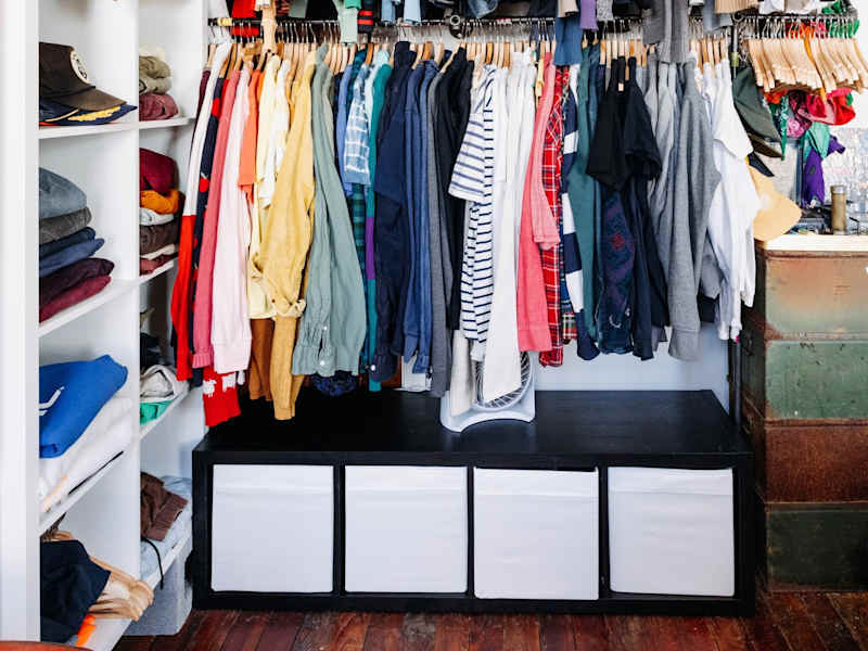 Clothing hangs in an exposed closet.
