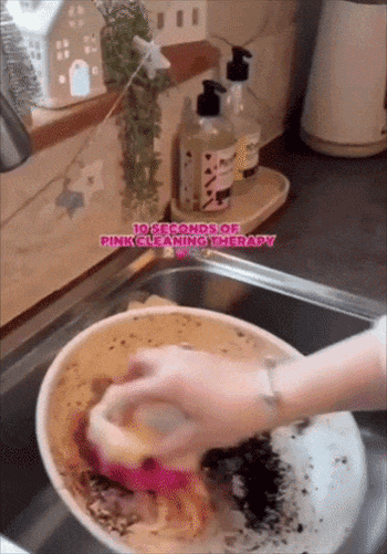 Hand scrubbing a dirty bowl in a sink with soapy sponge labeled