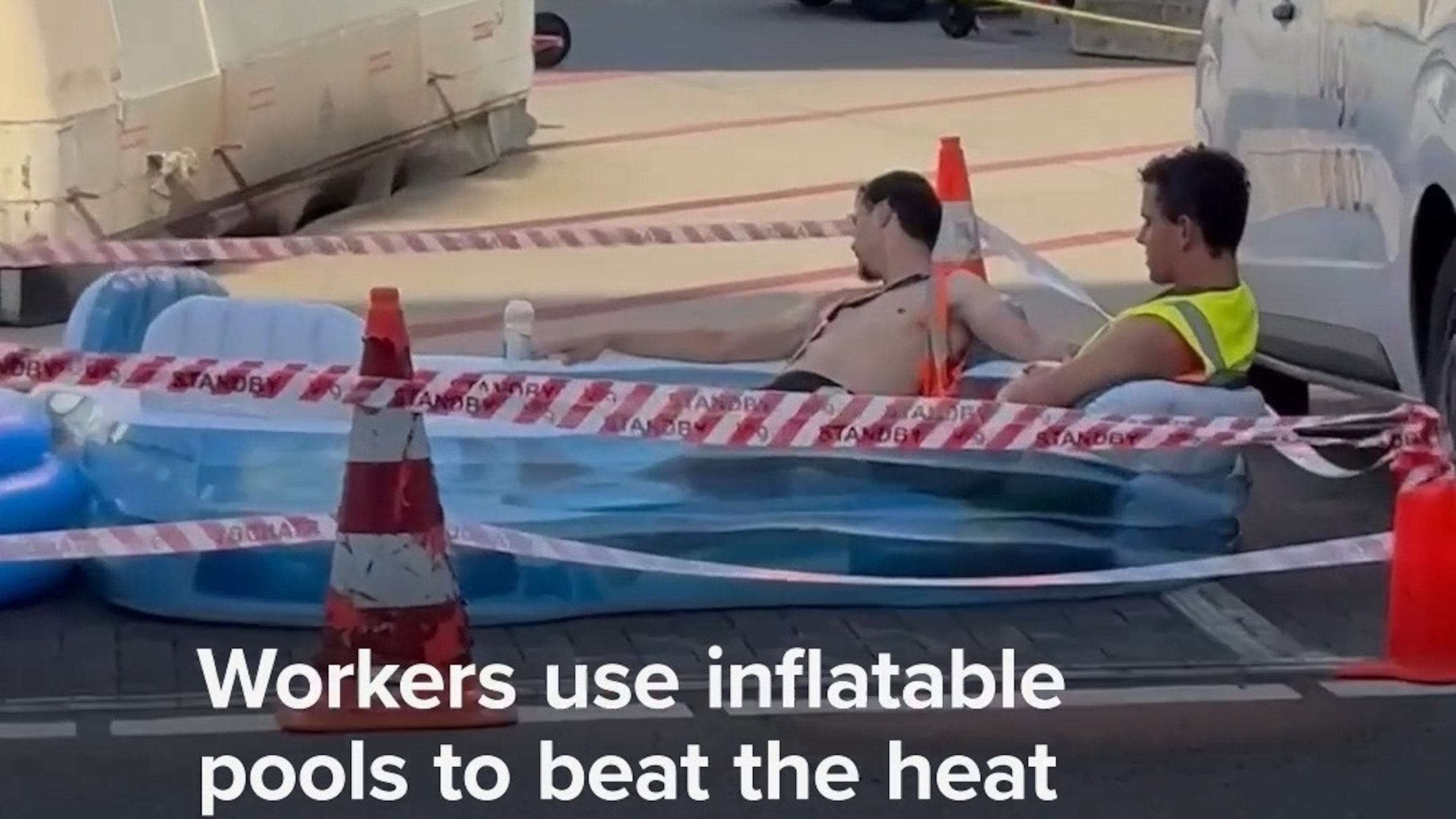 Workers use inflatable pools to beat the heat on airport tarmac