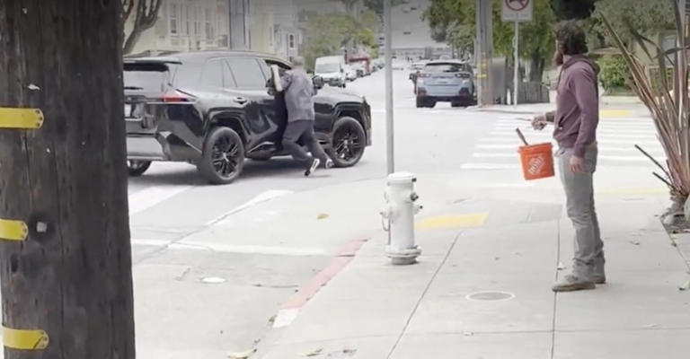 Angry man seen dangling off the side of car in San Francisco road rage ...